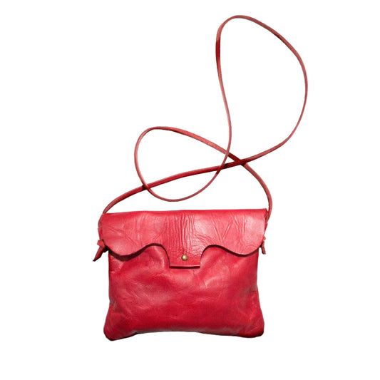 Cartera de cuero hecha a mano en color rojo, con correa ajustable vista desde el frente.